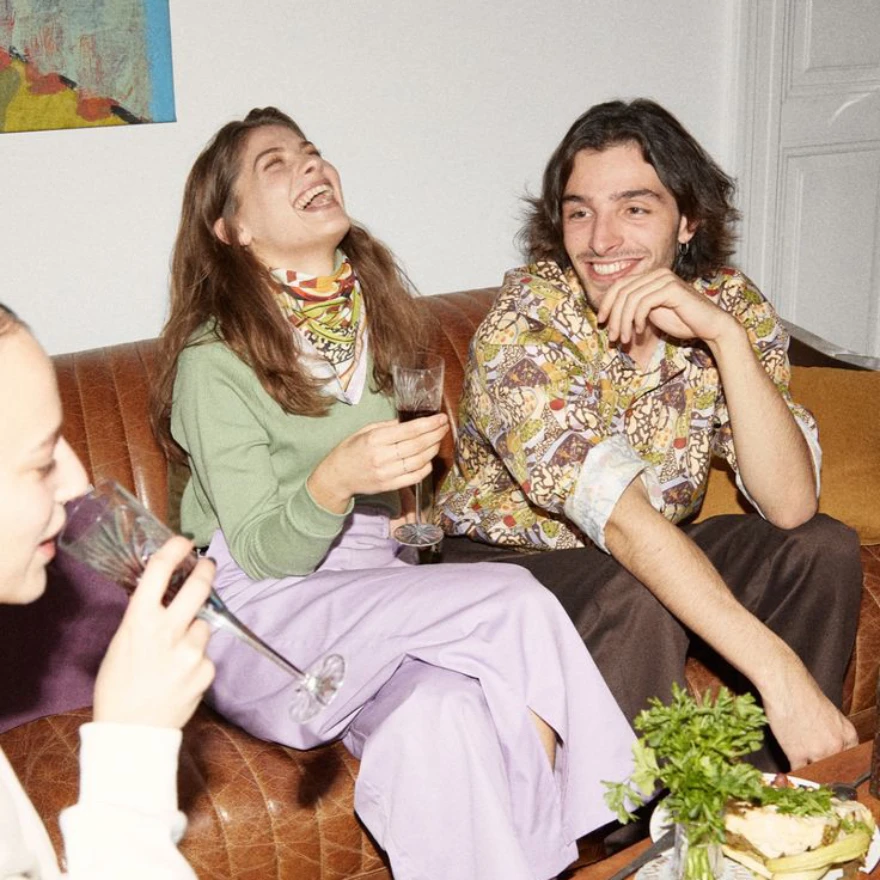 Friends laughing on the couch